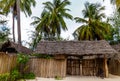 Pavilion with thatched roof and green palm trees around Royalty Free Stock Photo