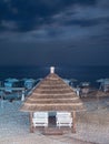 pavilion with white benches standing near the sea