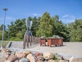 Pavilosta town center with flowers and Martina Lina sculpture monument