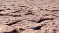 Paving blocks made of asymmetrical stone. Red wall with stone masonry, background, texture