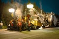 Paving crew preparing to start work on a road at night Royalty Free Stock Photo