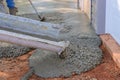 While paving a driveway, concrete construction contractors are pouring wet concrete while pouring wet concrete Royalty Free Stock Photo