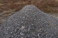 Paving gravel heap pile mound of building pavement construction material small stones pebble of gray quartz