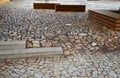 Paving gray brown beige color of natural stone boulders of irregular shapes and colors. Benches around a square and rectangular Royalty Free Stock Photo