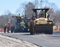 Paving machine, roller & crew on a highway project