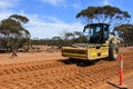 Paving roller machine flatting a dirt road surface in Western Australia
