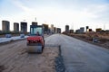Paving roller machine during road work. Road roller at construction site for paving works. Screeding the sand for road concreting Royalty Free Stock Photo