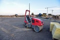 Paving roller machine during road work. Mini road roller at construction site for paving works. Screeding the sand for road Royalty Free Stock Photo