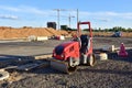 Paving roller machine during road work. Mini road roller at construction site for paving works. Screeding the sand for road Royalty Free Stock Photo