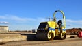 Paving roller machine during road work. Mini road roller at construction site for paving works. Screeding the sand for road Royalty Free Stock Photo