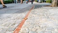Paving stone sidewalk with walking people Royalty Free Stock Photo