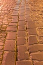 Paving stone vintage road cover. Evening road in a historical place. texture paving stones night road. vertical photo Royalty Free Stock Photo