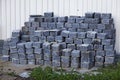 Paving stones stacked in piles at the house wall