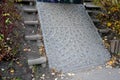 Paving under the bridge in the park, anti-erosion strengthening of embankment slope. paving of granite cubes in shape of mosaic ar