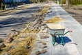 Paving works of the street edge during the reconstruction of the street, empty wheelbarrow