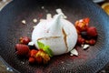 Pavlova berry cake with passion cream, strawberry, meringue. Delicious sweet dessert food closeup served for lunch in Royalty Free Stock Photo