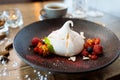 Pavlova berry cake with passion cream, strawberry, meringue. Delicious sweet dessert food closeup served for lunch in