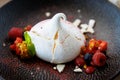 Pavlova berry cake with passion cream, strawberry, meringue. Delicious sweet dessert food closeup served for lunch in