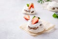 Pavlova berry cakes with strawberries, chocolate and mint. Royalty Free Stock Photo