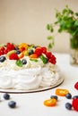 Pavlova cake with cream and fresh summer berries. Close up of Pavlova dessert with forest fruit and mint Royalty Free Stock Photo