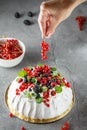 Pavlova cake with cream and fresh summer berries. Close up of Pavlova dessert with forest fruit and mint Royalty Free Stock Photo