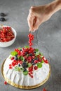 Pavlova cake with cream and fresh summer berries. Close up of Pavlova dessert with forest fruit and mint. Food photography. The Royalty Free Stock Photo