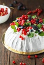 Pavlova cake with cream and fresh summer berries. Close up of Pavlova dessert with forest fruit and mint Royalty Free Stock Photo