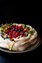 Pavlova cake with tonka cream and berries