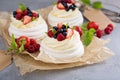 Pavlova cakes with cream and fresh berries