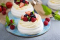 Pavlova cakes with cream and fresh berries