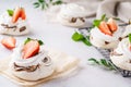 Pavlova cakes with cream and fresh summer berries. Royalty Free Stock Photo