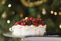 Pavlova with cream & berries, a favourite Australian dessert at Christmas time.