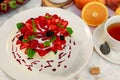 Pavlova dessert with cream mint and strawberry in a white plate on a white table Royalty Free Stock Photo