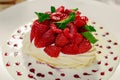 Pavlova dessert with cream mint and strawberry in a white plate on a white table Royalty Free Stock Photo