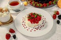 Pavlova dessert with cream mint and strawberry in a white plate on a white table Royalty Free Stock Photo
