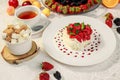 Pavlova dessert with cream mint and strawberry in a white plate on a white table Royalty Free Stock Photo