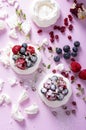 Pavlova meringue cake with cream and berries on dusted sugar pink background