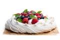 Pavlova meringue nest with berries and mint leaves isolated on white