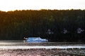 Pavlovsk Reservoir, Russia - August 10, 2018: ferry on background of mountaine forest, summer boat trip