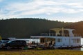 Pavlovsk Reservoir, Russia - August 10, 2018: white houseboat parked on the shore