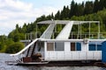 Pavlovsk Reservoir, Russia - August 10, 2018: white houseboat parked on the shore of the reservoir.