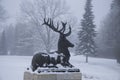 Bronze deer in profile in snow and frost in the winter