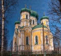 Pavlovsky Cathedral on a sunny spring day. The blue sky, green domes and the yellow walls of the cathedral. Gatchina