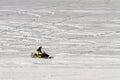 Pavlovsky Ski Park, Russia - March 10, 2018: man riding on snowmobile on background of white snow