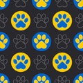 Paw of a cat or dog. Blue and yellow paws of animals on a black background. Cute seamless pattern.