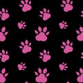 Paw pattern, seamless vector pattern silhouettes of paw, cat s feet, dog s footprint. Pink on black background. Royalty Free Stock Photo