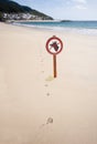 Paw prints and no dogs sign on beach Royalty Free Stock Photo