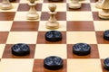 Pawn and checkers piece in center of board closeup Royalty Free Stock Photo