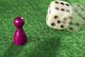 Pawn and a dice in motion Royalty Free Stock Photo