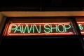 Pawn shop sign glowing from a dark window Royalty Free Stock Photo